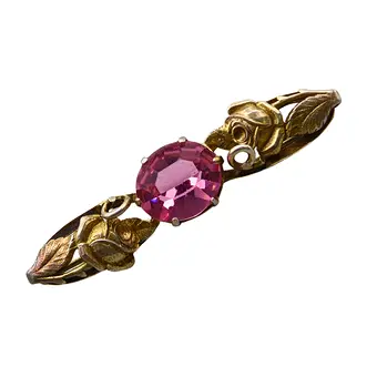 Jugendstil messing broche en gefacetteerde paarse glassteen.