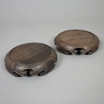A pair of round Chinese wooden stands.