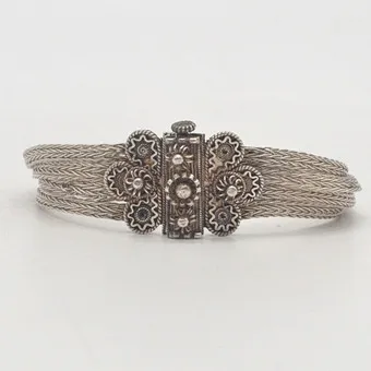Silver bracelet, floral decoration, wire art, tested 925, four braided chains, clasp, early 20th century.