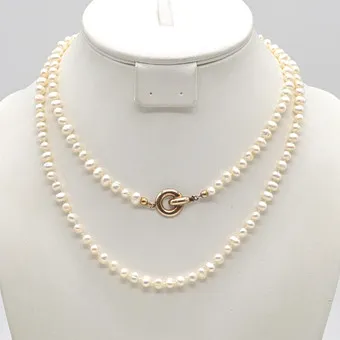 Pearl necklace, white cultured pearls, slightly off-round, individually knotted, gold-plated sterling silver clasp, 20th century.