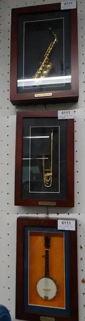 5 small musical instruments behind glass
