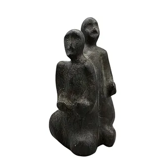 ABSTRACT STONE SCULPTURE OF TWO PEOPLE.