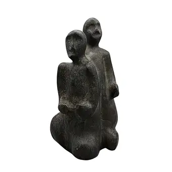 ABSTRACT STONE SCULPTURE OF TWO PEOPLE.