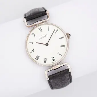 Vintage-rannekello, merkki Symbol, «Swiss Made», musta nahkaranneke, käsivetoinen.