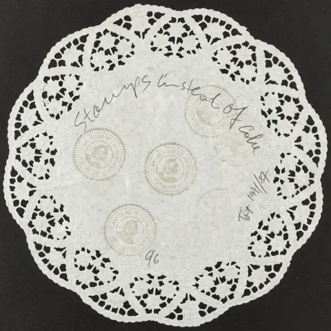 Fluxus – Tót, Endre. Stamps instead of cake. Papieren kleedje met meerdere stempels.