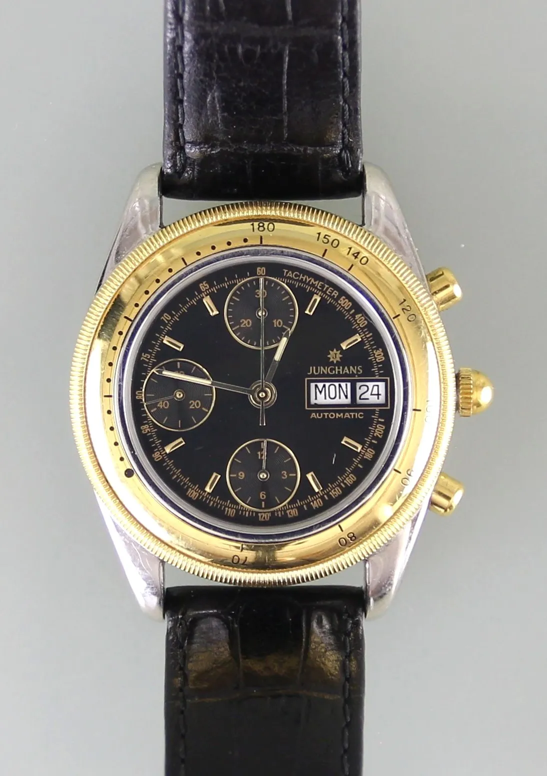 Gents' wristwatch "Junghans Day Date Chronograph" – stainless steel case with rotating gilded bezel and glass back, automatic movement calibre ETA 7750