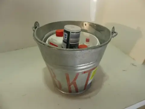 Paket, između ostalog pocinčana kanta s sadržajem (bočice s raspršivačem, boce)
