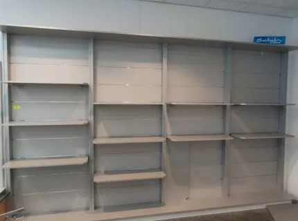 1 presentation shelf with back panel, approx. 2.20 m x 3.60 m, grey, with 12 shelves, partly worn