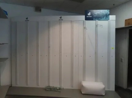 1 wall presentation system, inscription Deuter, approx. 2.20 m x 3 m wide, white, screwed, with vertical perforated panel rails and 15 hook strips, chrome-plated