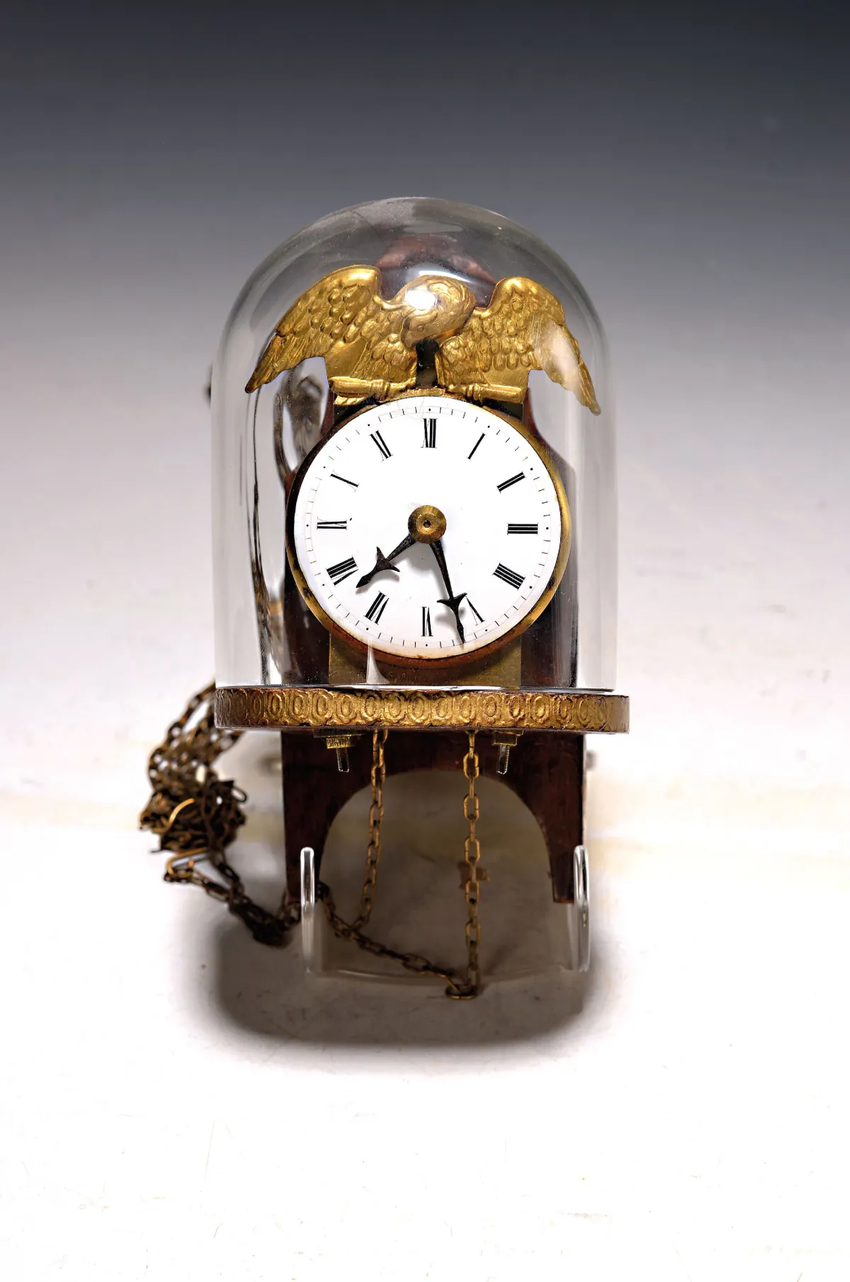 Small wall clock with glass dome, South German, circa 1820, mounted on wooden base