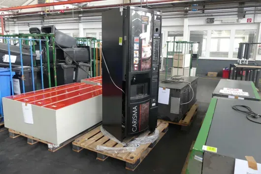 Hot beverage vending machine, probably defective, with pallet