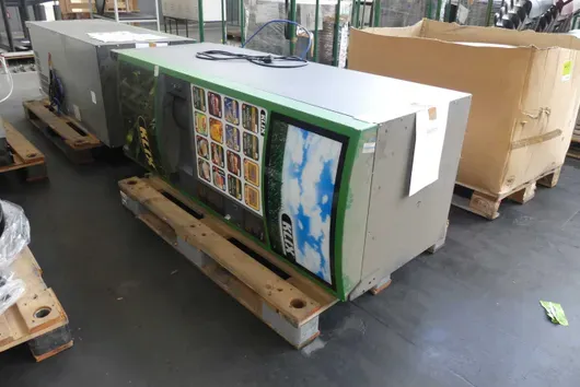 Hot beverage vending machine, probably defective, with pallet