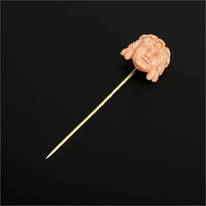Pin with Greek-style coral carving
