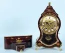 Table clock with wall console "Eluxa" – curved red case with brass fittings, hand-painted with floral motifs, brass-colored dial…