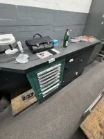 1 workbench (homemade) with contents, 3 base cabinets and shelving