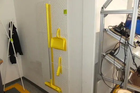 Perforated wall with cleaning utensils