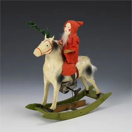 Kerstman op mechanisch schommelpaard