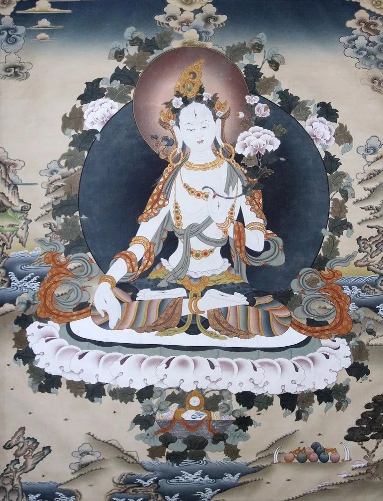 White Tara – The Buddhist goddess of compassion seated on a lotus, surrounded by plants in an ideal landscape